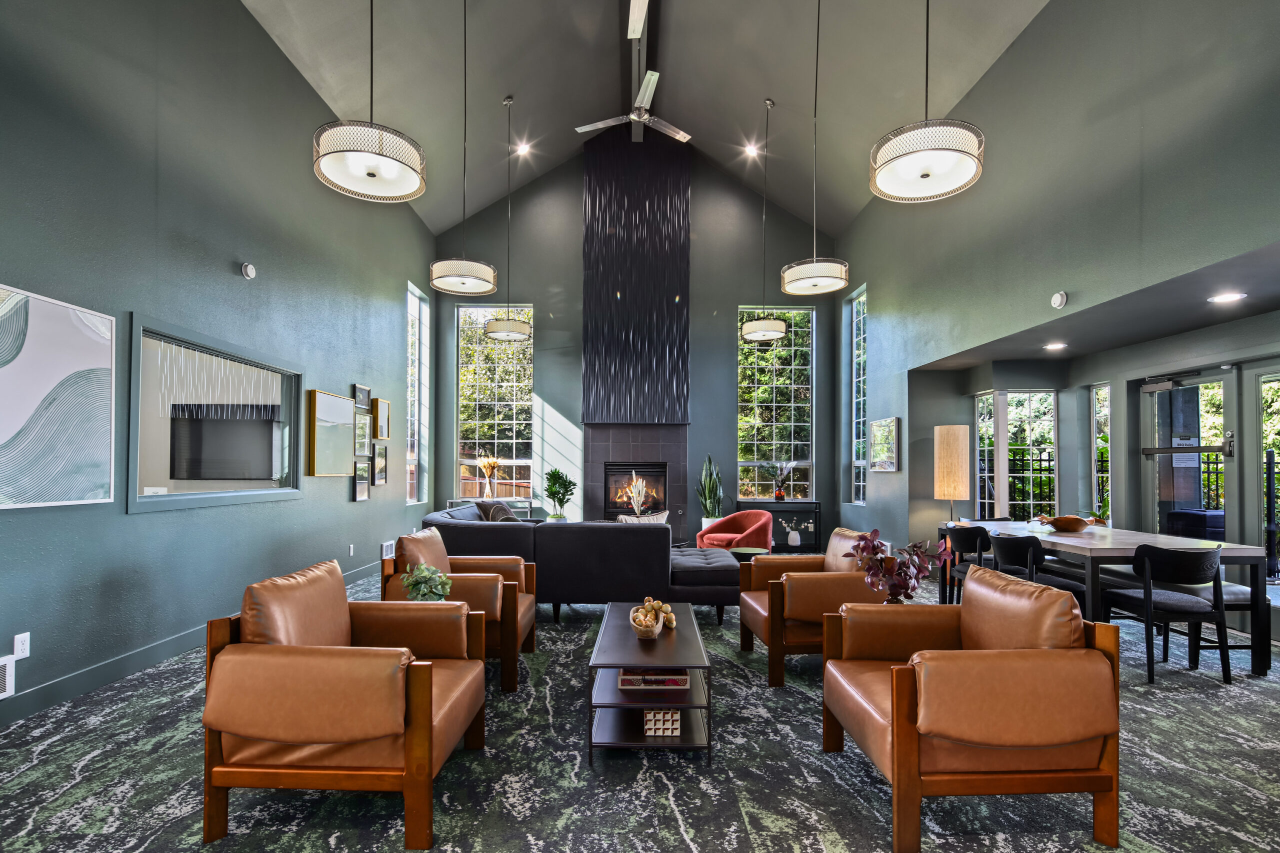 A newly renovated common area with a variety of seating options and a contemporary fireplace, designed for both relaxation and conversation.